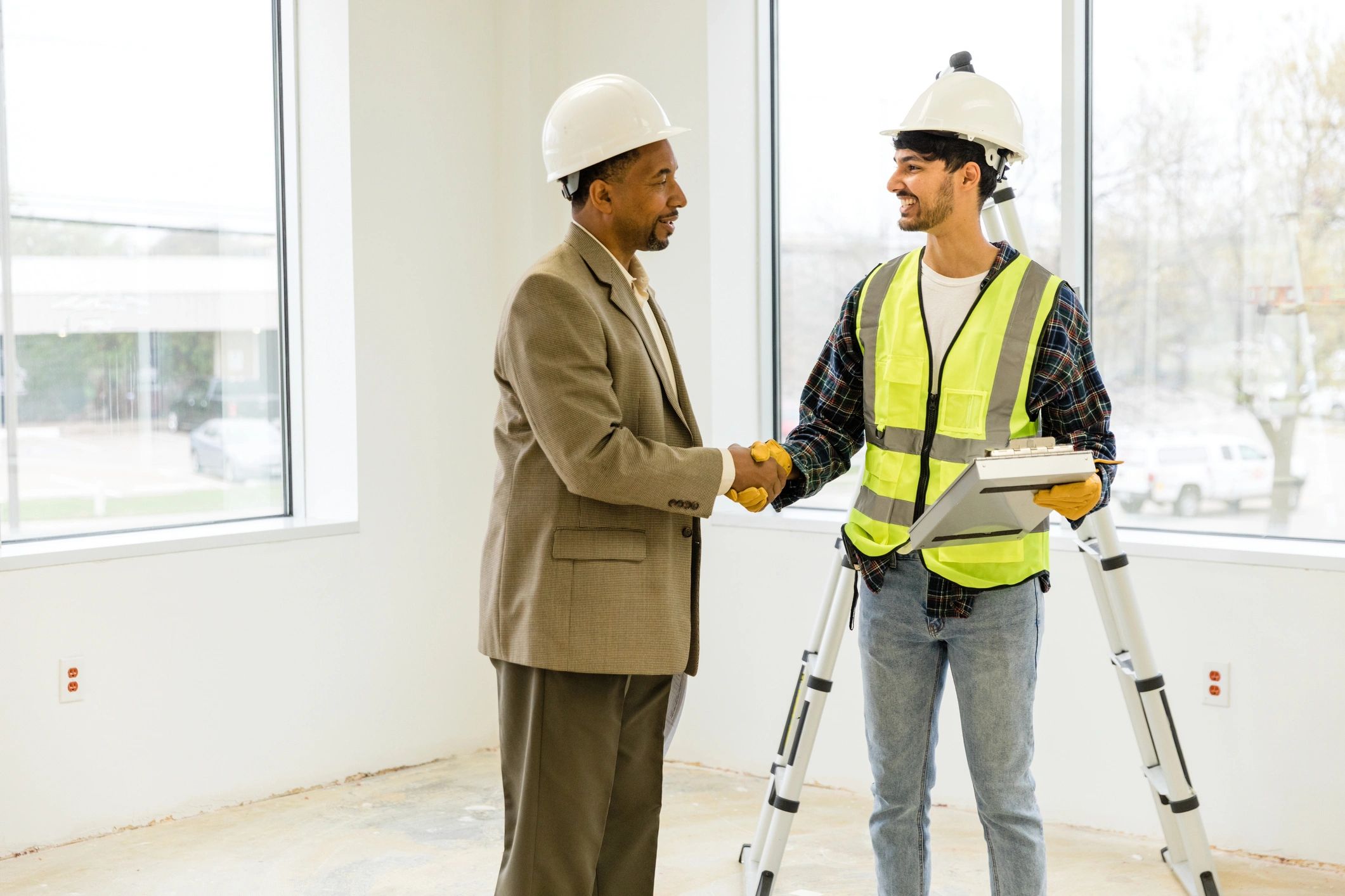 Project manager greeting a client at a renovation jobsite