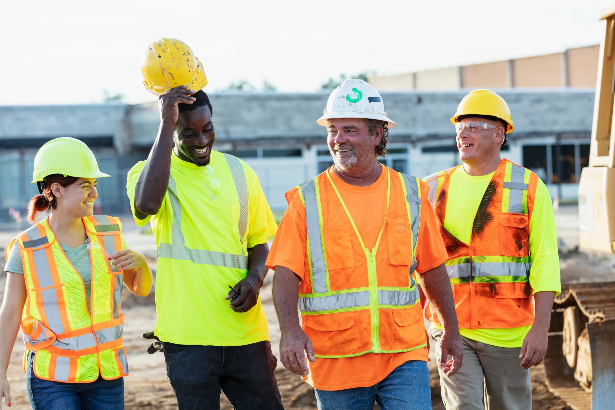 Construction team walking through a jobsite discussing plans