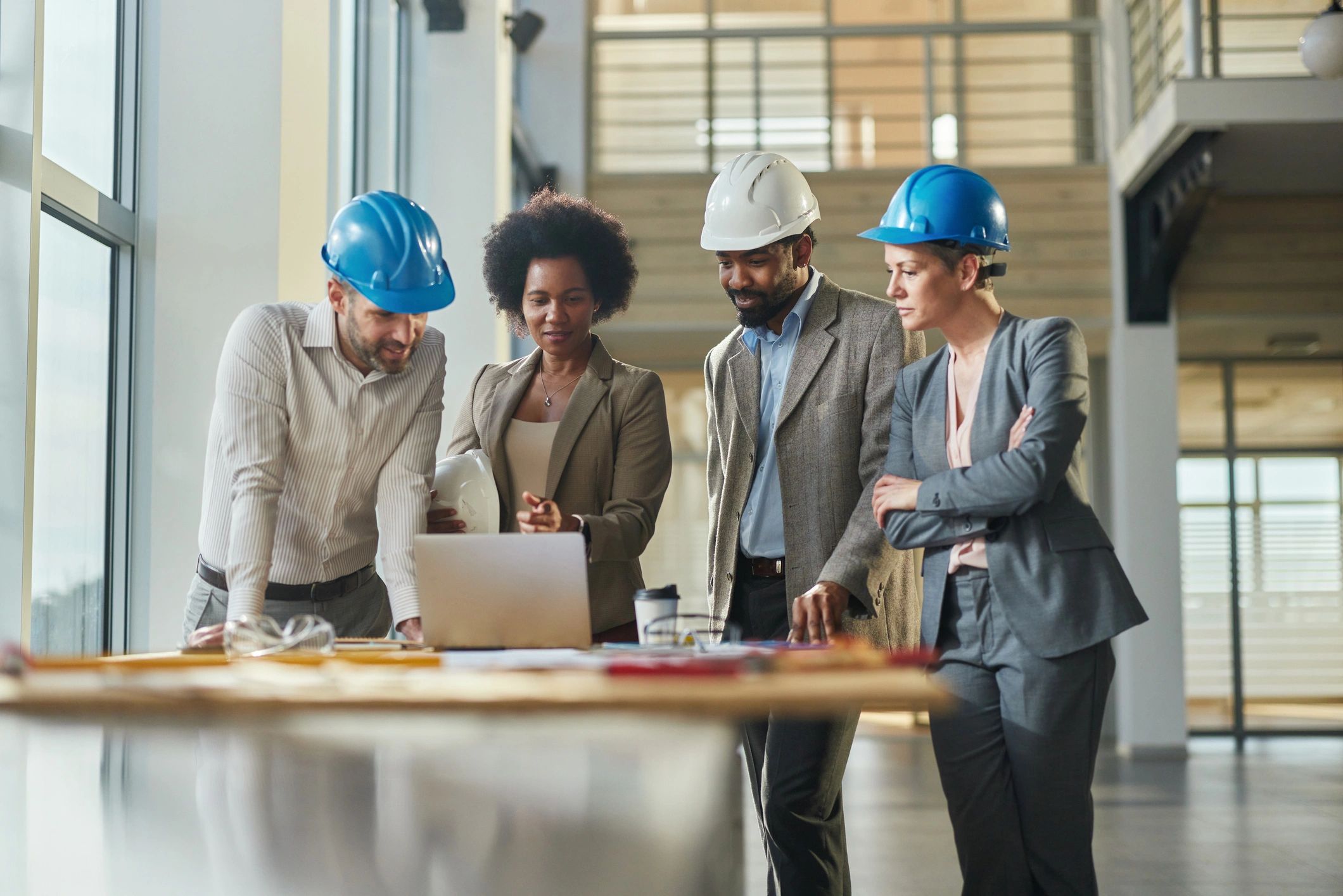 Project managers working on a laptop at a construction site