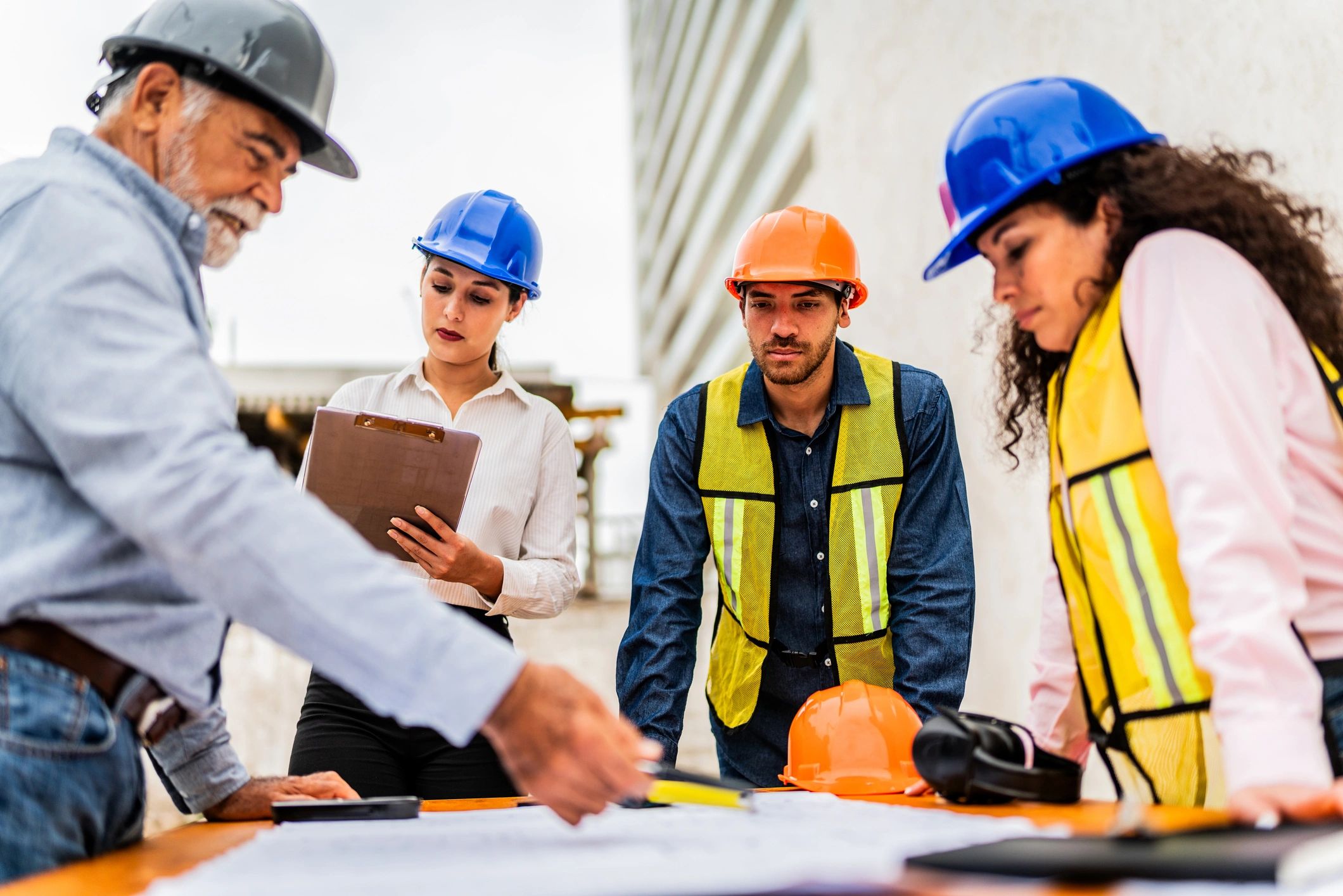 Construction team reviewing blueprints on a jobsite