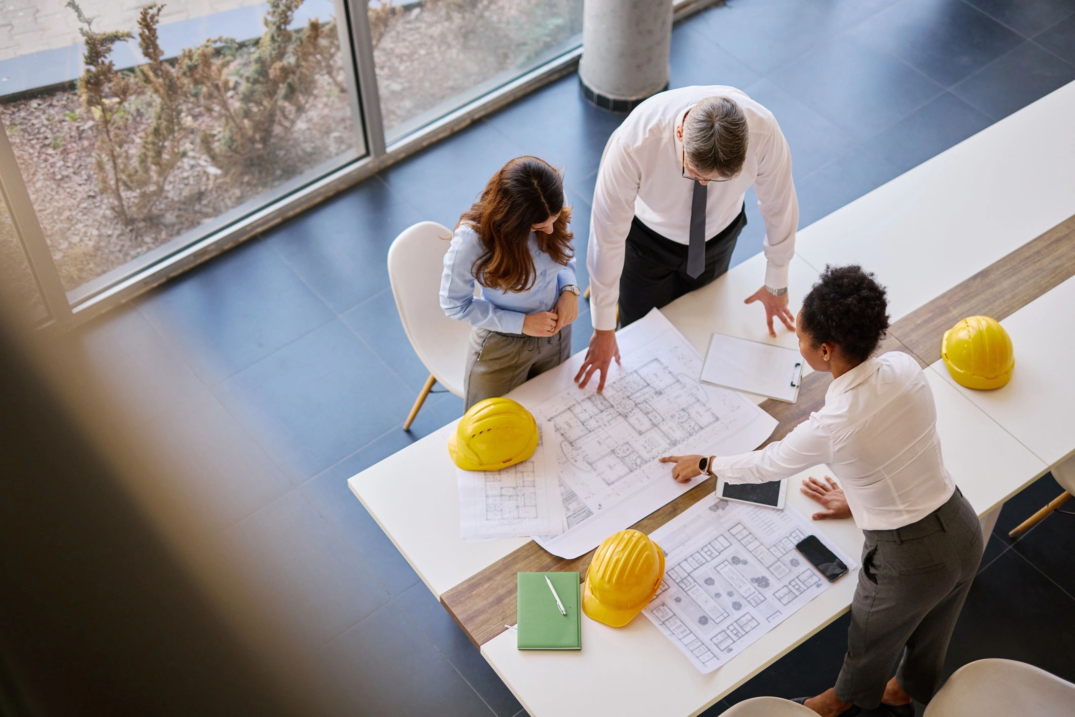 Architects collaborating over blueprints in a modern office