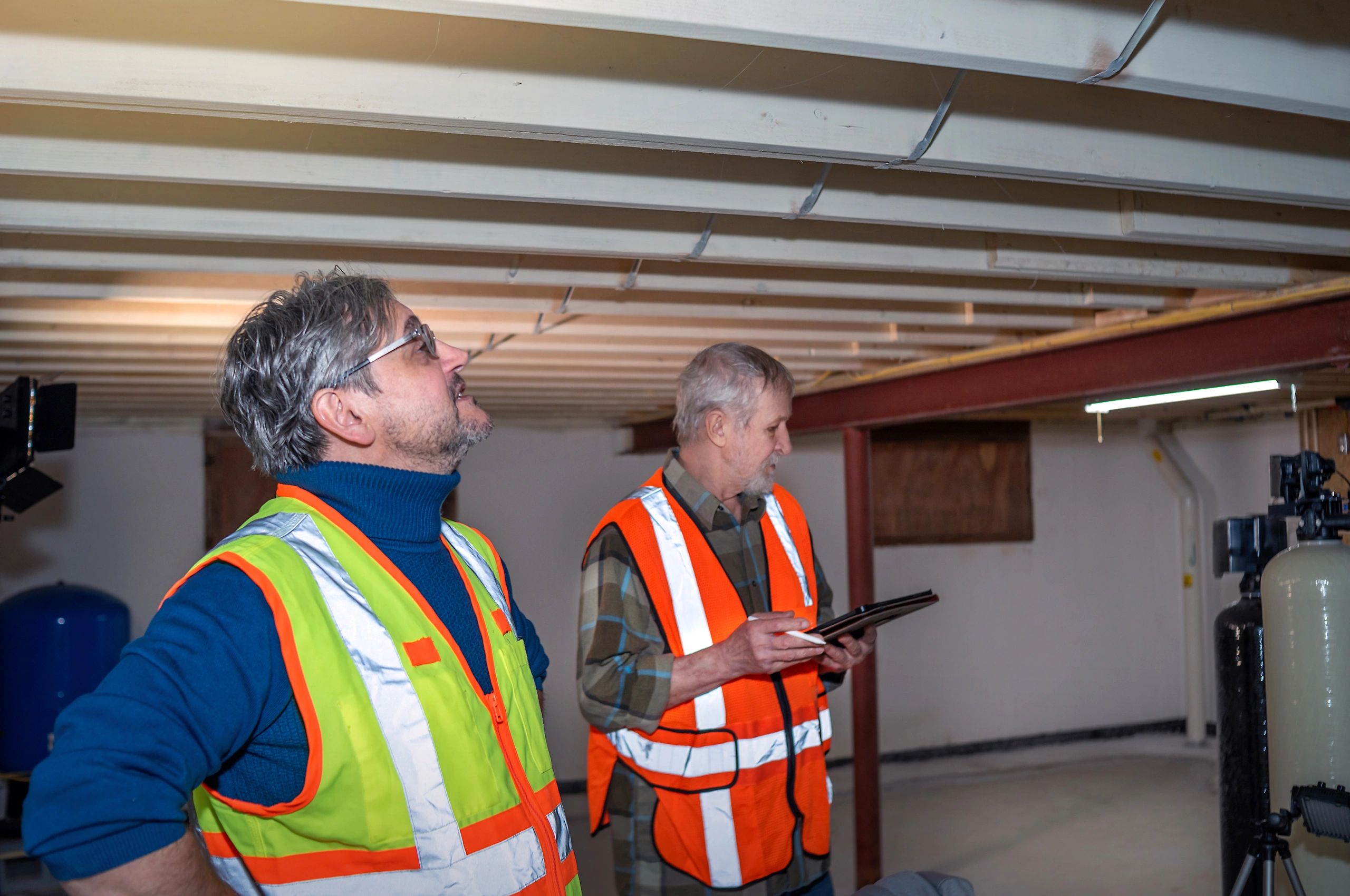 Engineers inspecting structural beams in an unfinished building